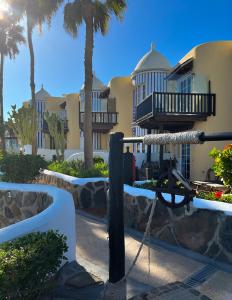 a view of a resort with palm trees at Amazing Apartment Altamar 2 in Playa del Aguila