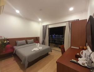 a bedroom with a bed with a swan on it at 4 RIVERS HOTEL in Phnom Penh