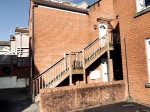 a staircase on the side of a brick building at Stylish city flat with private parking in Bristol