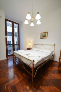 a bedroom with a large bed with a wooden floor at Neapolitan Soul By Dimorra in Naples