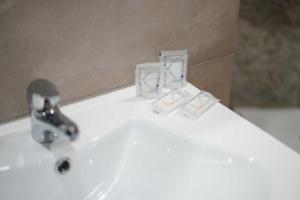 a white sink with a faucet on top of it at Neapolitan Soul By Dimorra in Naples