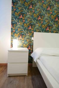 a bedroom with a bed and a floral wallpaper at Neapolitan Soul By Dimorra in Naples