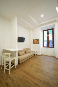 a living room with a couch and a table at Neapolitan Soul By Dimorra in Naples