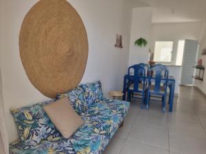 a living room with a couch and two blue chairs at Vila Girassol in Aracaju