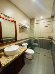 a bathroom with a sink and a toilet and a shower at Jen Hotel in Tuy Hoa