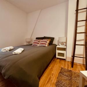 a bedroom with a bed with two pillows on it at AMPLE Conciergerie in Cierp