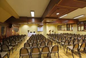 a conference room with chairs and a screen in the middle at Hotel El Puma in Cusco