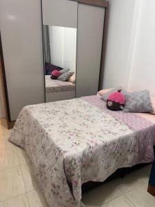 a bedroom with a bed with a pink stuffed animal on it at Loft no coração da Lapa in Rio de Janeiro