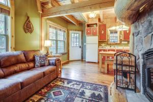 a living room with a couch and a fireplace at Rustic Retreat Walk to Great Sacandaga Lake! in Broadalbin