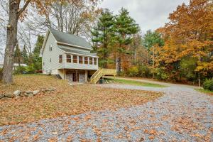 a house on a road with leaves on the ground at Rustic Retreat Walk to Great Sacandaga Lake! in Broadalbin