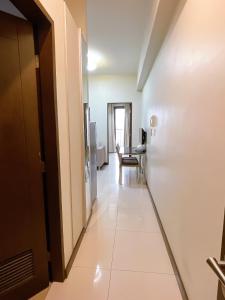 a corridor of a room with a white hallway at Admiral Baysuites 1 BR Unit in Manila