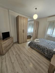a bedroom with a bed and a television in it at Zeffirino Apartments in Sanremo