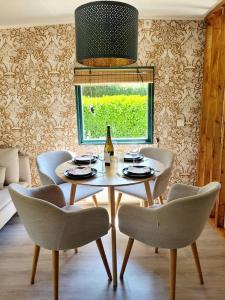 a dining room with a table and chairs and a window at Natuurhuisje De Zwaluw in Putten