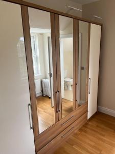 a sliding glass door in a room with a toilet at clover cottage in Kinsale