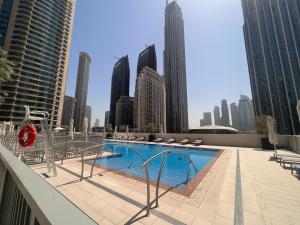 a swimming pool on the roof of a building with buildings at Forte Downtown Dubai in Dubai