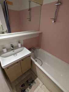 ein Badezimmer mit einem Waschbecken und einer Badewanne in der Unterkunft Central spacious flat with private parking in Chamonix-Mont-Blanc