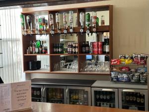a bar with a lot of bottles of alcohol at Luther King House in Manchester