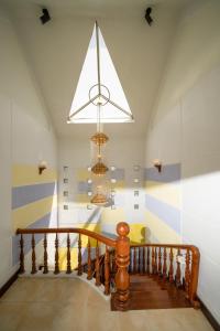 a hallway with a staircase with a chandelier at S Villa Đà Nẵng Gần Biển in Da Nang