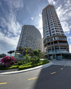 two tall buildings in a city with a street at Apec Mandala Wyndham Mui Ne Ngoc Linh in Ấp Long Sơn