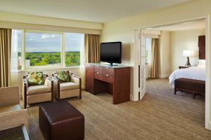 a hotel room with a bed and a flat screen tv at The Westin Waltham Boston in Waltham