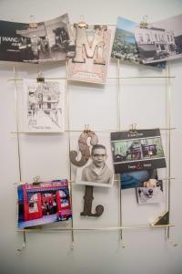 a wall with pictures and photographs on it at The Flat a Wanderlust Abodes property in Central Lake