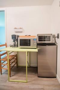 a table with two microwaves and a microwave on it at The Flat a Wanderlust Abodes property in Central Lake