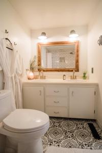 W łazience znajduje się toaleta, umywalka i lustro. w obiekcie The Flat a Wanderlust Abodes property w mieście Central Lake