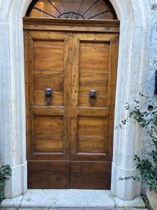 a large wooden door in a stone building at A un passo dal castello in Pacentro