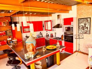 una cocina con armarios rojos y una estatua en un mostrador en Apartamento Pacifico, en Viña del Mar