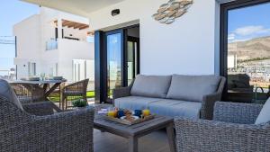 a living room with a couch and chairs and a table at PANORAMIC pool & mountains house in Finestrat