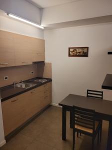 a kitchen with a table and a sink at AFFITTACAMERE GENIUS in Bondeno