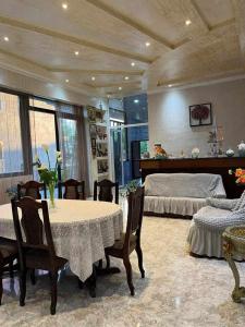a room with two beds and a table and chairs at TikTok house in Kobuleti