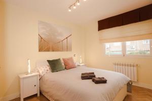 a bedroom with a bed with two towels on it at Madrid sofia resort in Madrid