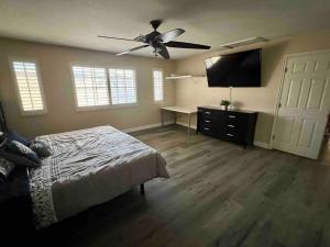 a bedroom with a bed and a ceiling fan at Plush Las Vegas Retreat 5 min from Strip in Las Vegas