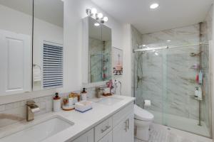 a white bathroom with a sink and a shower at Newly Built Maple Valley Vacation Rental with Patio! in Maple Valley +26 photos