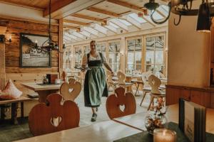 a woman standing in a room with wooden hearts at Alpe Dornach in Oberstdorf