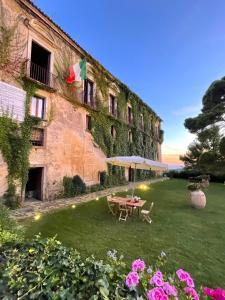 a garden with a table and an umbrella in front of a building at Palazzo Mazziotti in Celso