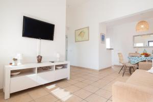 a living room with a flat screen tv on the wall at Vent de Xaloc in Sa Ràpita