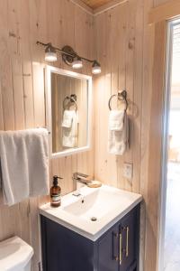 a bathroom with a sink and a mirror at Petals oceanview villa 