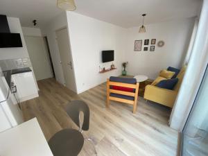 a living room with a couch and a table at Appartement en bord de mer 1 in Banyuls-sur-Mer