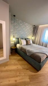 a bedroom with a large bed with a wall at Belle Vue Malaga Suite in Málaga