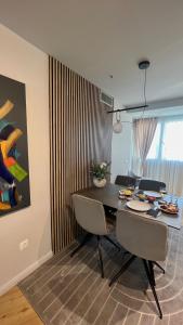 a dining room with a table and chairs and a painting at Belle Vue Malaga Suite in Málaga