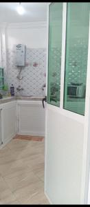 a white door in a kitchen with a counter at A 5 minutos del aeropuerto de fes in Oulad Tayeb