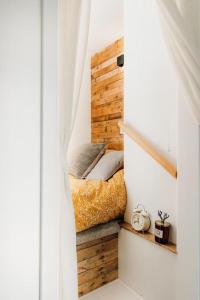 a bedroom with a bed on a wooden wall at Superb Tiny Home in Caldicot with Parking in Caldicot