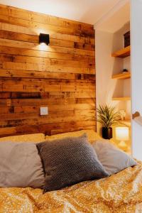 a bedroom with a wooden accent wall and a bed at Superb Tiny Home in Caldicot with Parking in Caldicot