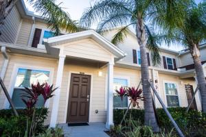 a house with palm trees in front of it at Townhome at West Lucaya Resort 3202 in Orlando