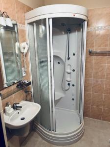 a bathroom with a shower and a sink at Penzion Villa Ancora in Šumperk