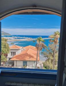 a view of the ocean from a train window at The Shell 200 mt dal mare con giardino in centro città - posto auto in Imperia
