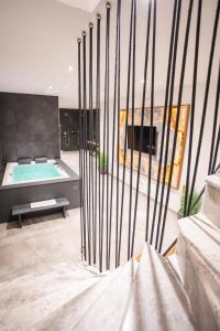 a large bathroom with a swimming pool and a tub at Private Spa & Garden Alpi in Garmisch-Partenkirchen