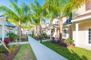 a walkway in front of a house with palm trees at Townhome at West Lucaya Resort 3212 in Orlando